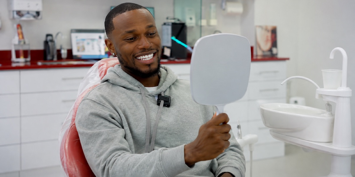 Patient reviewing smile result after dental implant treatment at Svelta Dental Design Miami